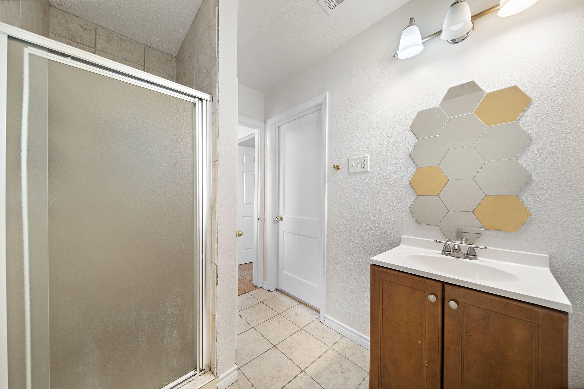 404 Milwaukee Street Houston, TX 77009 - Photo 6 of 19 a bathroom with a sink mirror and a shower