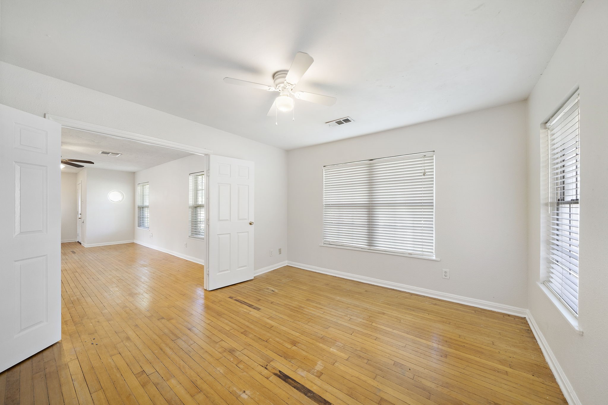 404 Milwaukee Street Houston, TX 77009 - Photo 8 of 19 a view of an empty room with wooden floor and a window