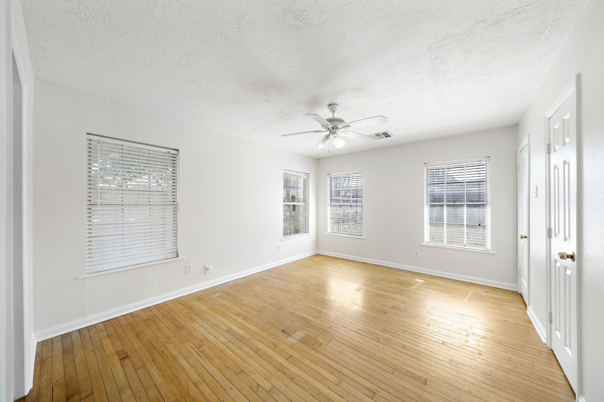 404 Milwaukee Street Houston, TX 77009 - Photo 9 of 19 a view of an empty room with wooden floor and a window