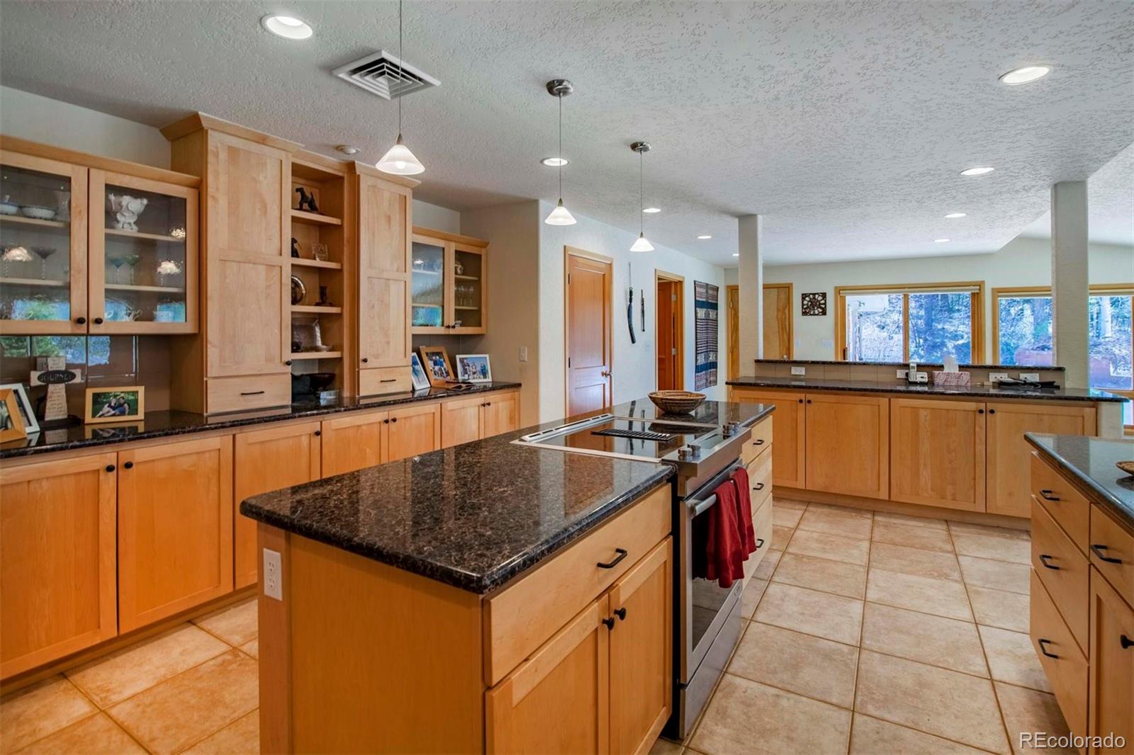 18332 Stone Gate Drive Morrison, CO 80465 - Photo 11 of 40 a kitchen with stainless steel appliances granite countertop a sink and a stove