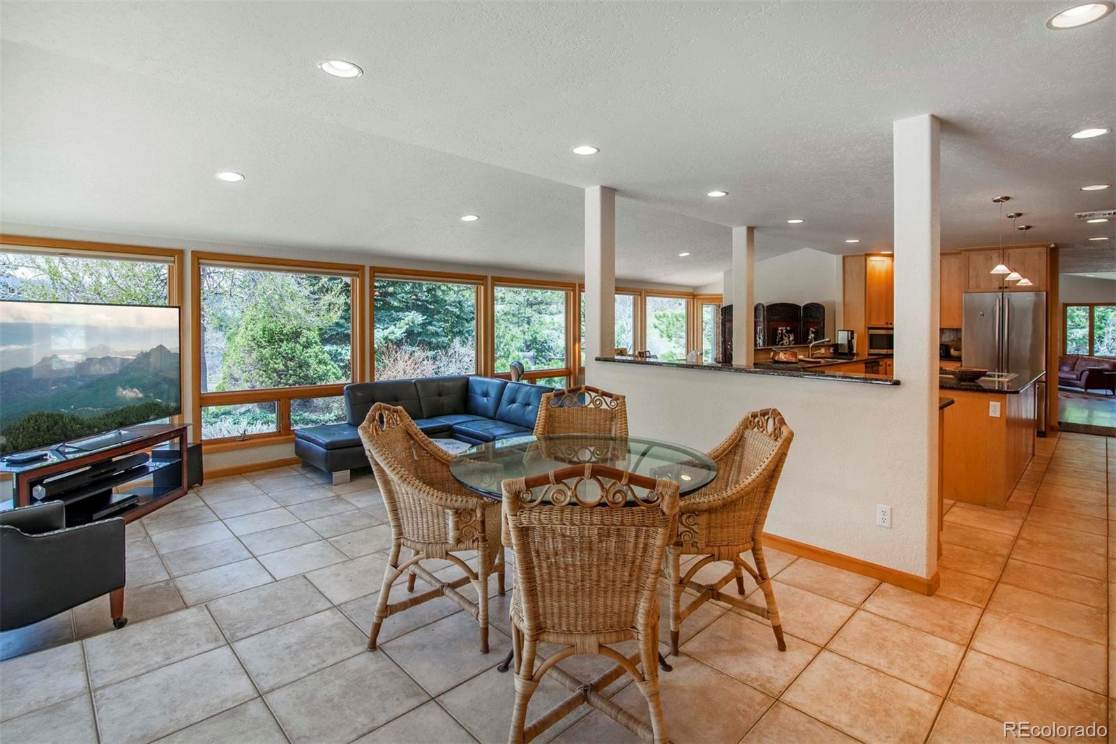 18332 Stone Gate Drive Morrison, CO 80465 - Photo 12 of 40 a view of a dining room with furniture a chandelier and kitchen view