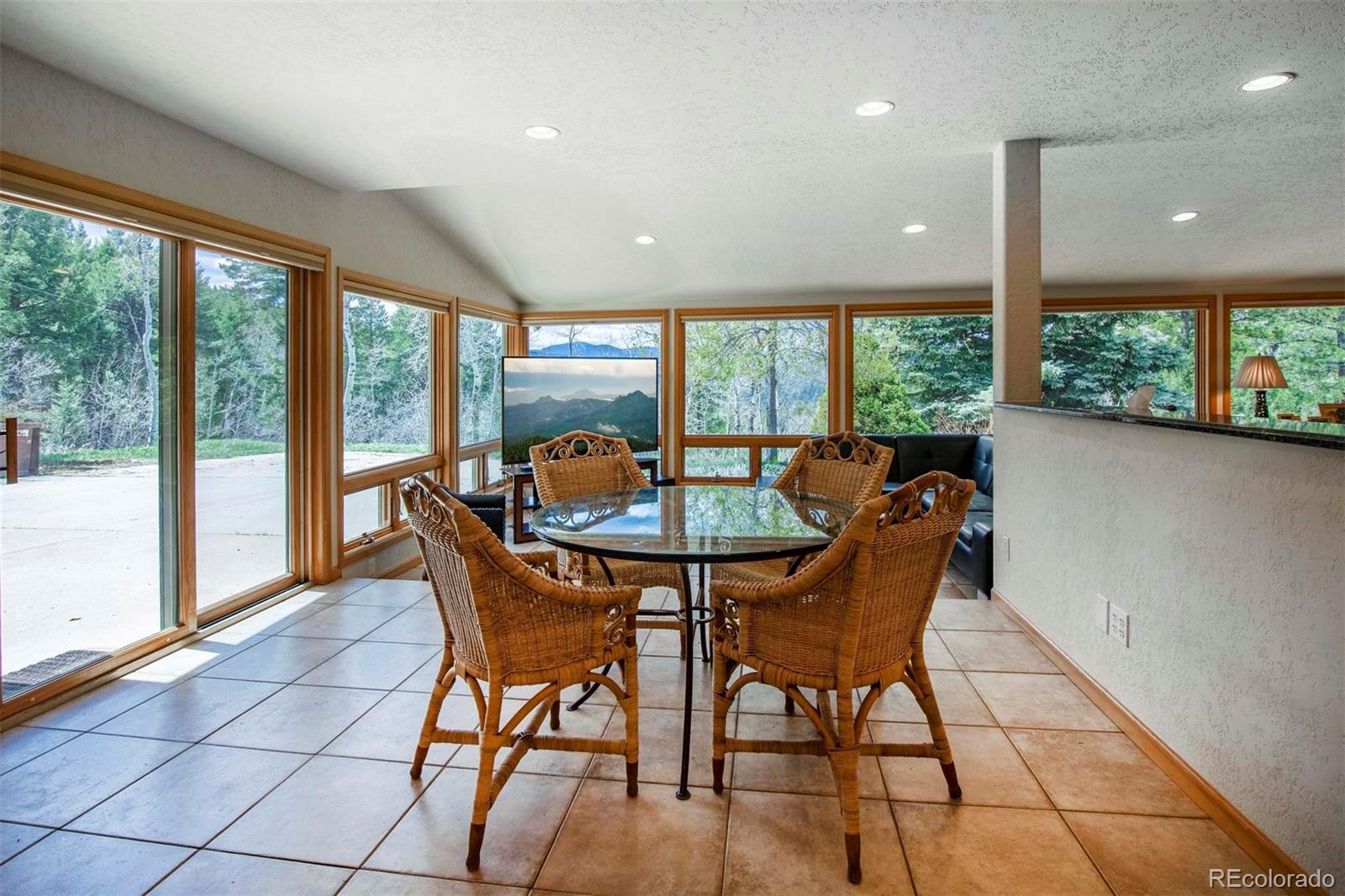 18332 Stone Gate Drive Morrison, CO 80465 - Photo 13 of 40 a dining room with furniture and window