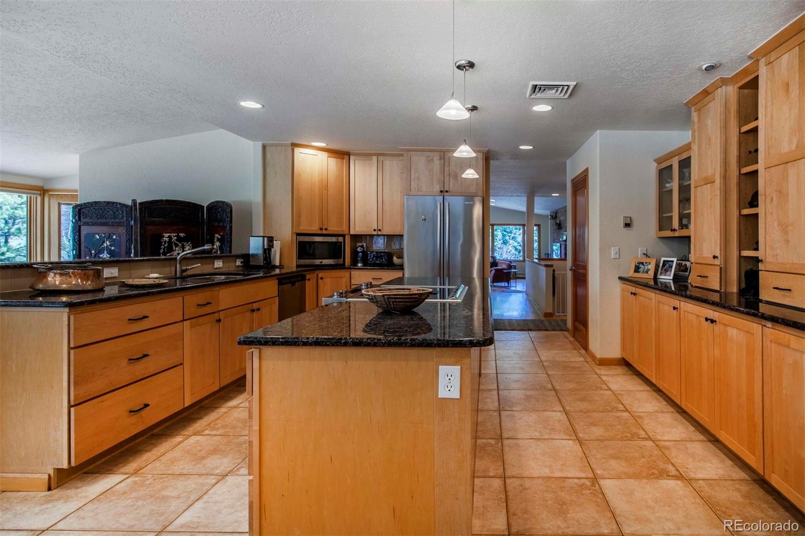 18332 Stone Gate Drive Morrison, CO 80465 - Photo 16 of 40 a large kitchen with stainless steel appliances lots of counter space and a sink