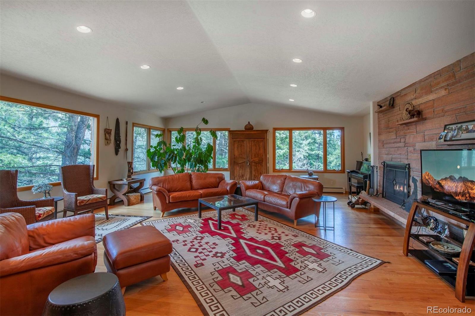 18332 Stone Gate Drive Morrison, CO 80465 - Photo 17 of 40 a living room with furniture a rug and a flat screen tv