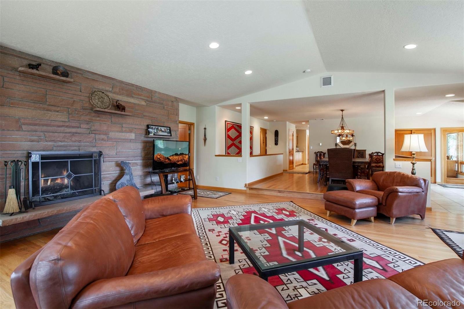 18332 Stone Gate Drive Morrison, CO 80465 - Photo 20 of 40 a living room with furniture and a wooden floor