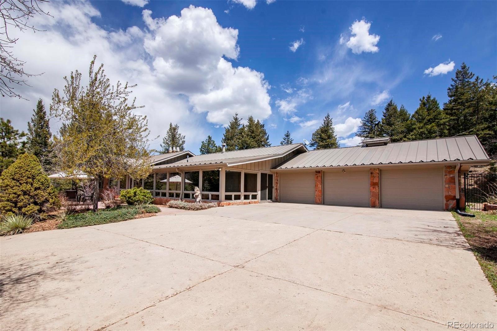 18332 Stone Gate Drive Morrison, CO 80465 - Photo 2 of 40 a view of a house with a yard