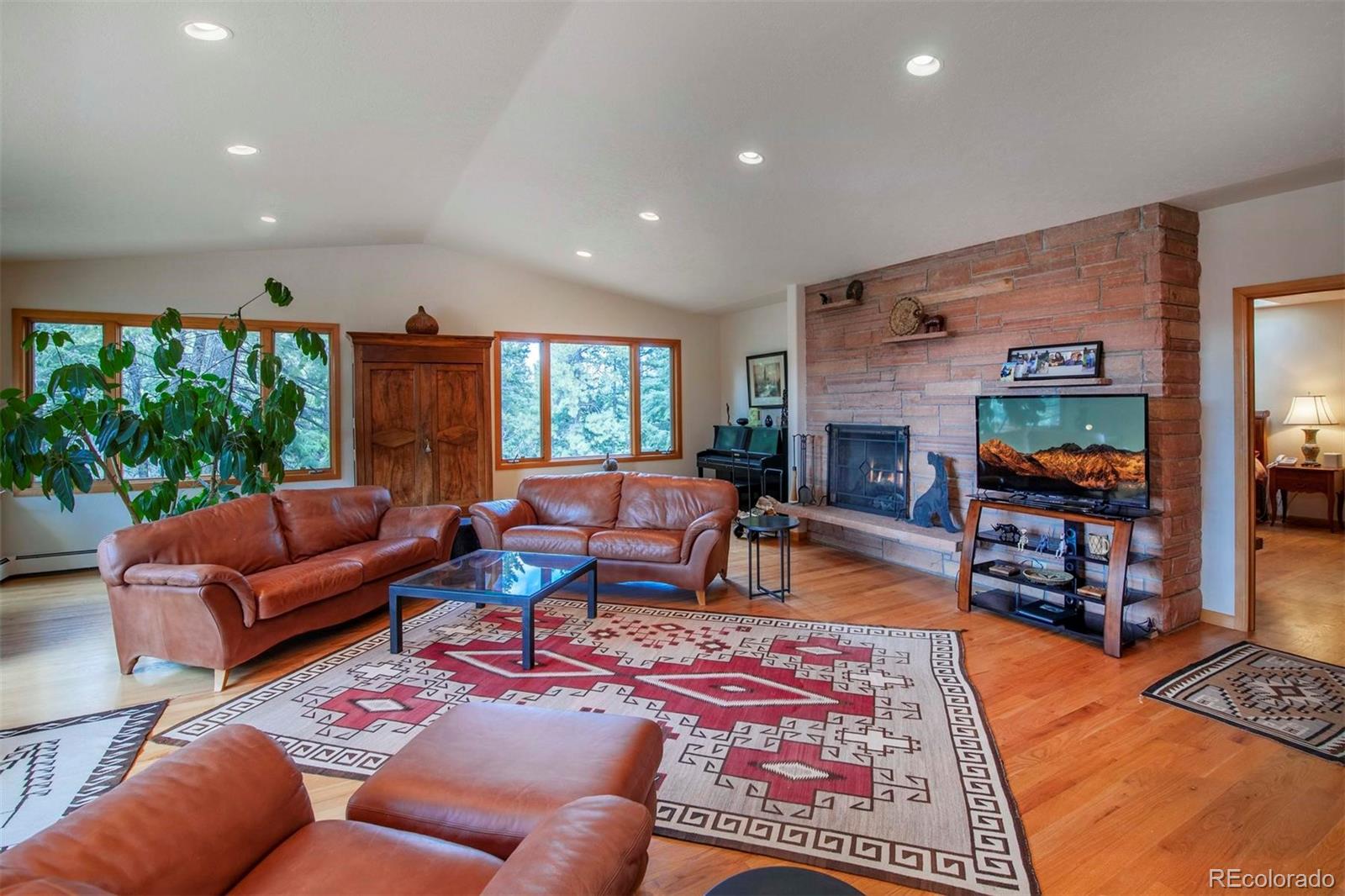 18332 Stone Gate Drive Morrison, CO 80465 - Photo 21 of 40 a living room with furniture a rug and a flat screen tv