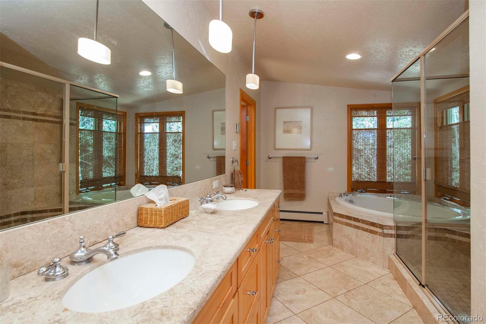 18332 Stone Gate Drive Morrison, CO 80465 - Photo 26 of 40 a bathroom with a granite countertop sink a toilet and a bathtub
