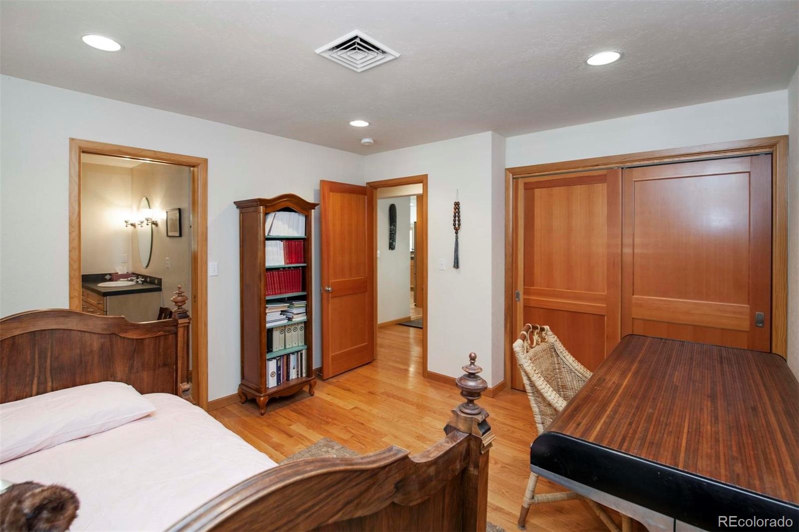 18332 Stone Gate Drive Morrison, CO 80465 - Photo 27 of 40 a bedroom with a bed and furniture