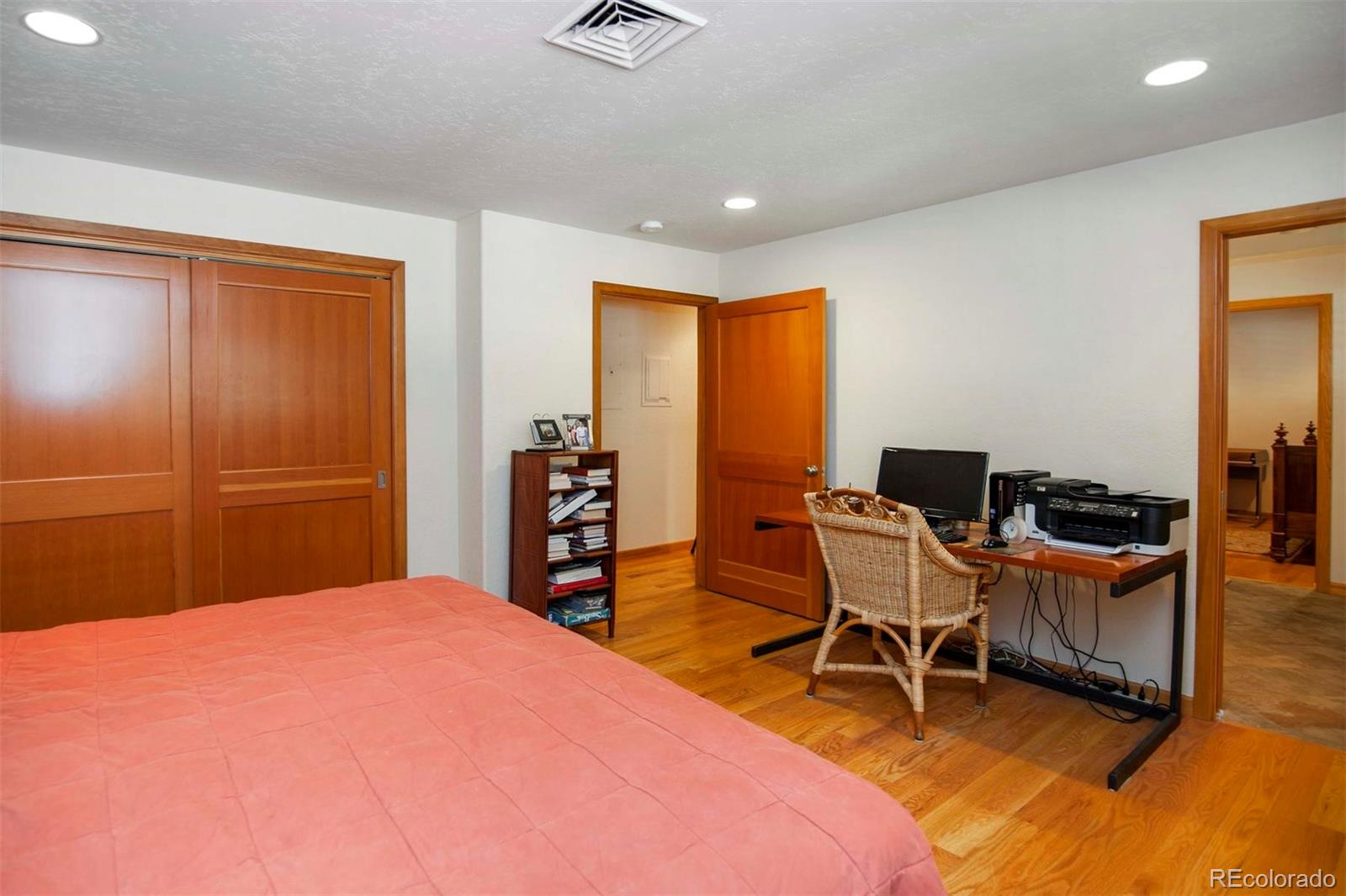 18332 Stone Gate Drive Morrison, CO 80465 - Photo 29 of 40 a bedroom with a bed and a desk