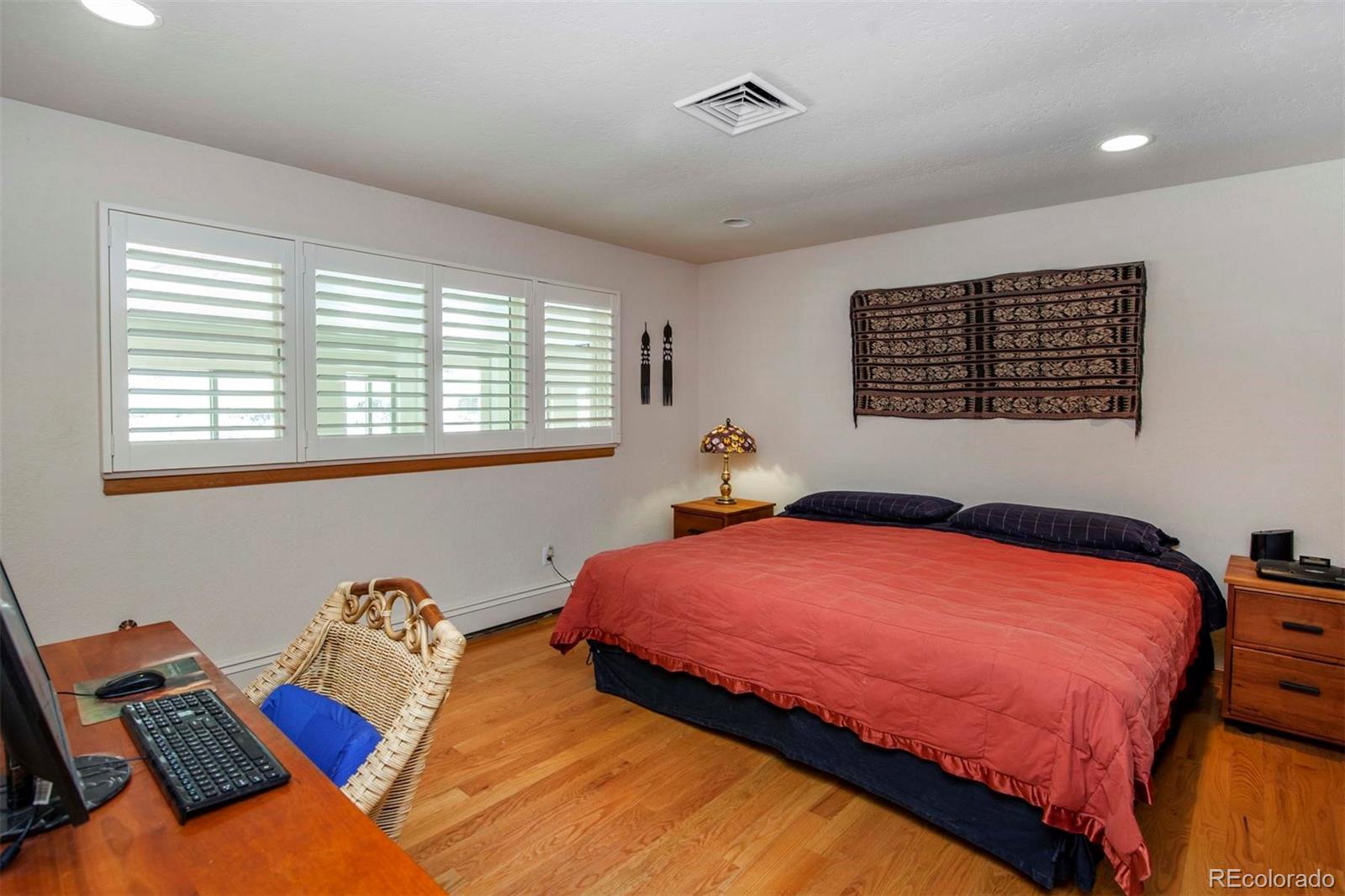 18332 Stone Gate Drive Morrison, CO 80465 - Photo 30 of 40 a bedroom with bed and a window