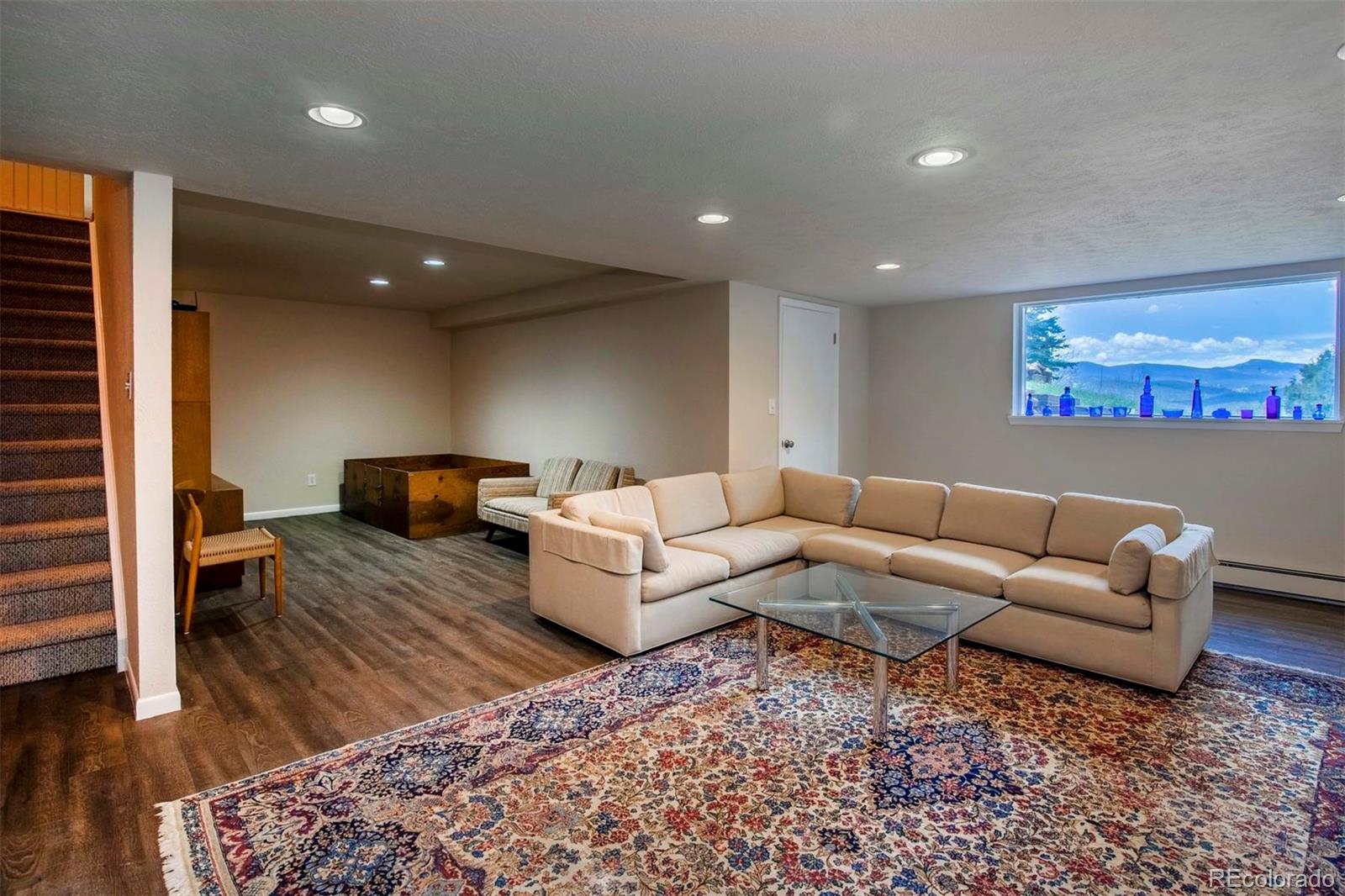 18332 Stone Gate Drive Morrison, CO 80465 - Photo 31 of 40 a living room with furniture and a rug