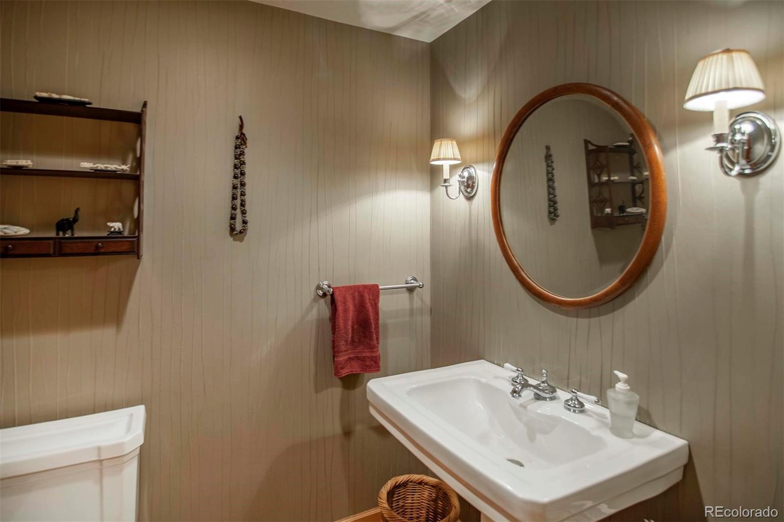 18332 Stone Gate Drive Morrison, CO 80465 - Photo 33 of 40 a bathroom with a sink and a mirror