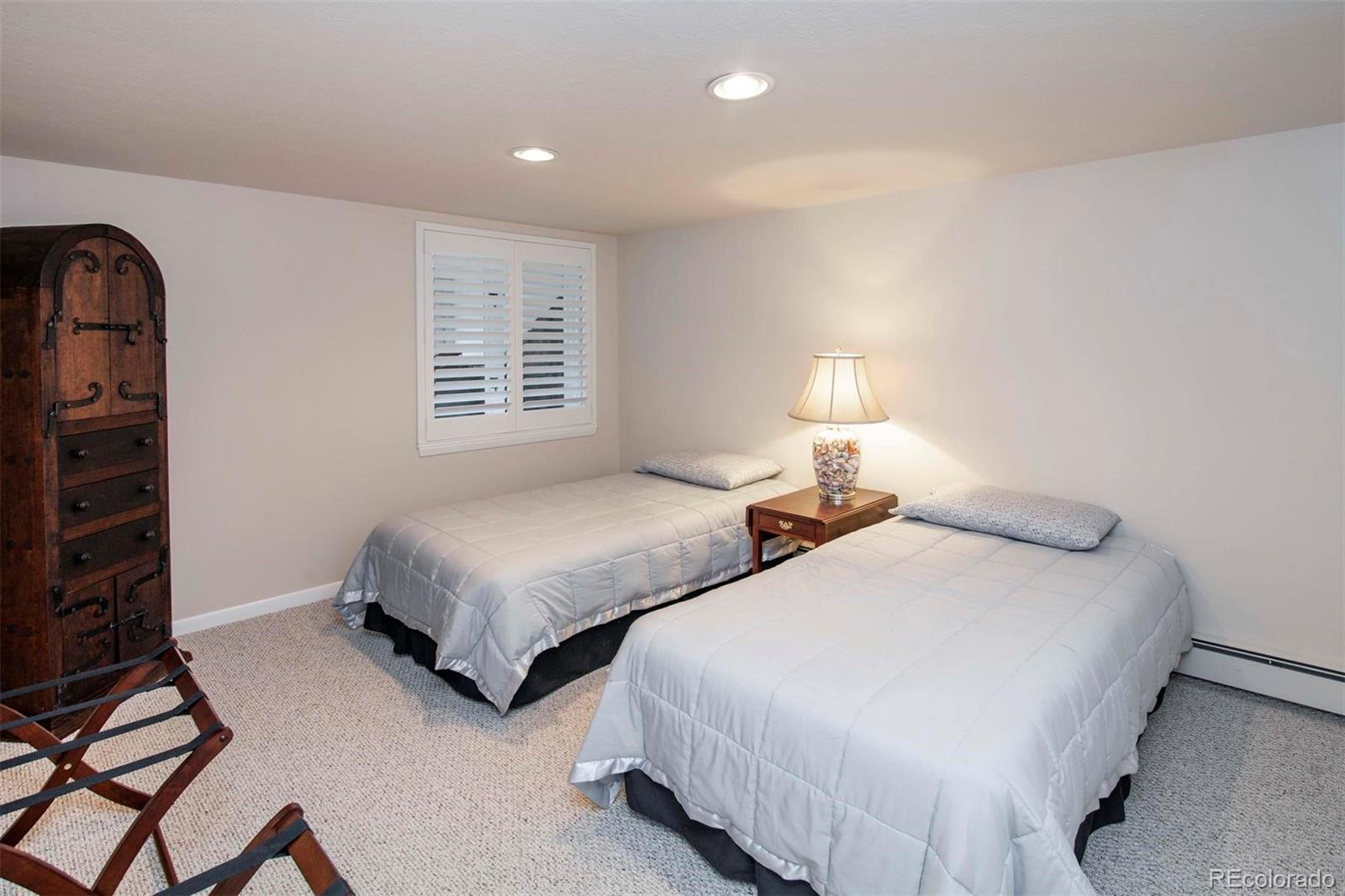 18332 Stone Gate Drive Morrison, CO 80465 - Photo 34 of 40 a bedroom with two beds and a window