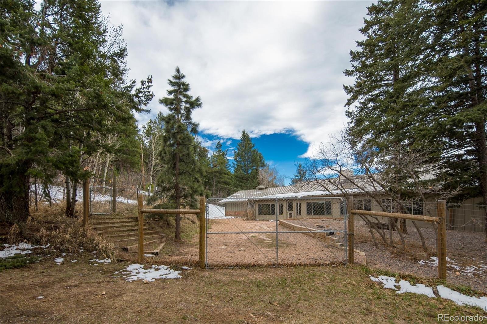 18332 Stone Gate Drive Morrison, CO 80465 - Photo 35 of 40 a front view of a house with a yard