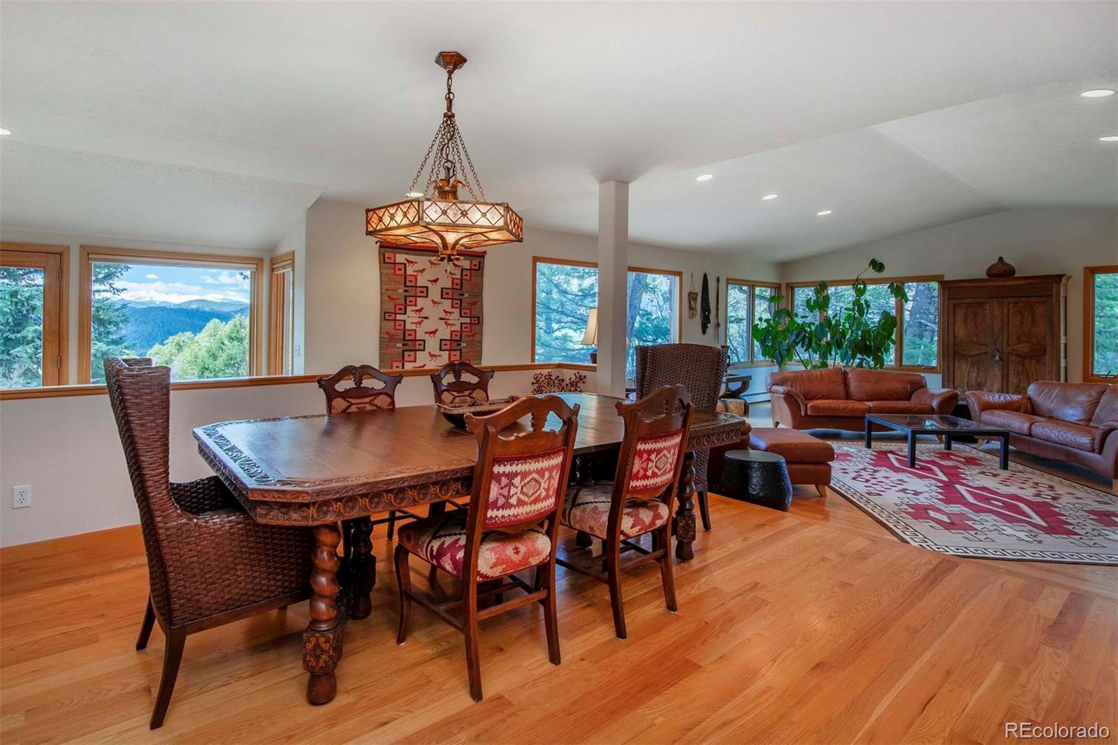 18332 Stone Gate Drive Morrison, CO 80465 - Photo 8 of 40 a view of a dining room with furniture window and wooden floor