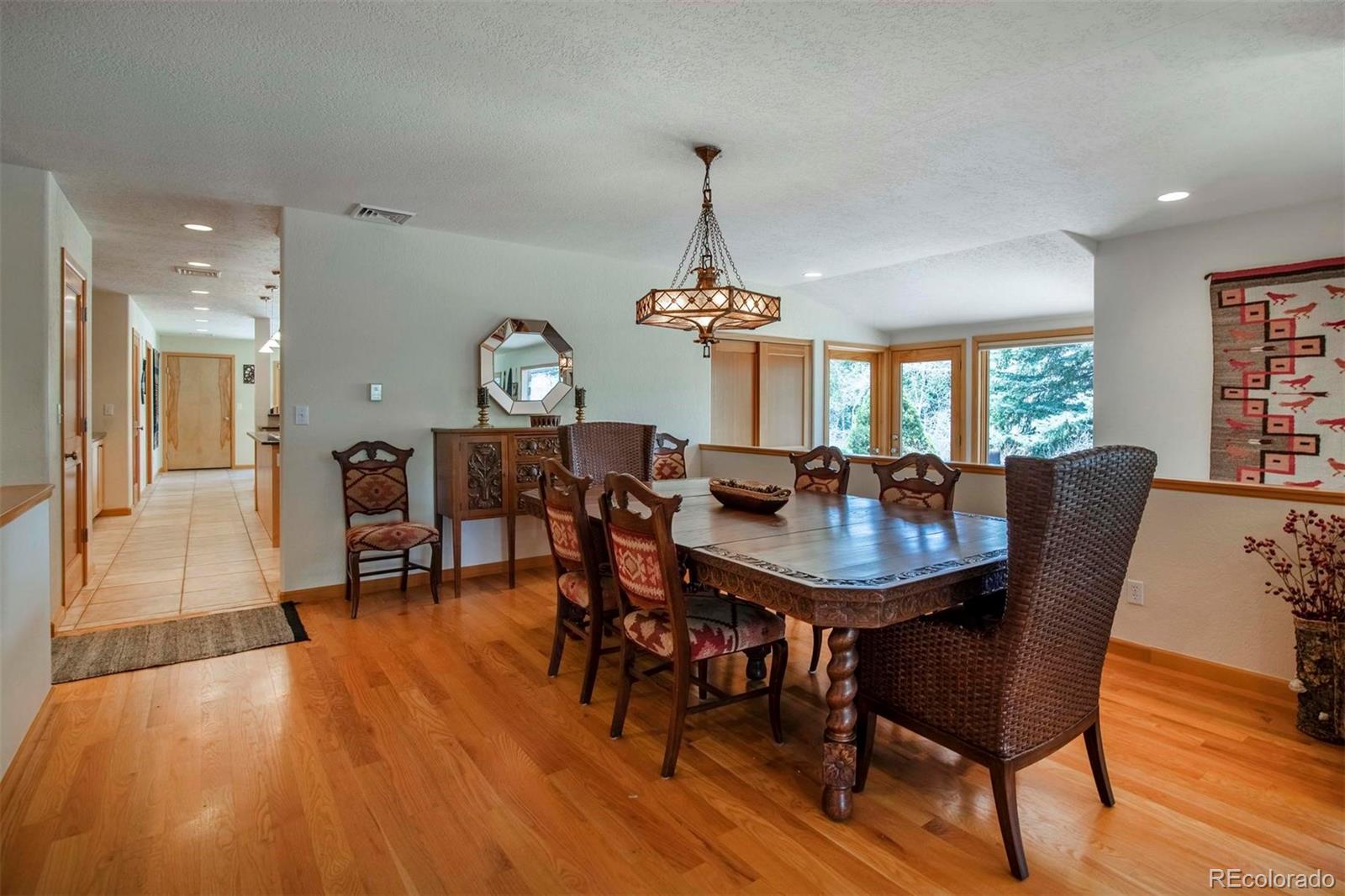 18332 Stone Gate Drive Morrison, CO 80465 - Photo 9 of 40 a view of a dining room with furniture window and wooden floor