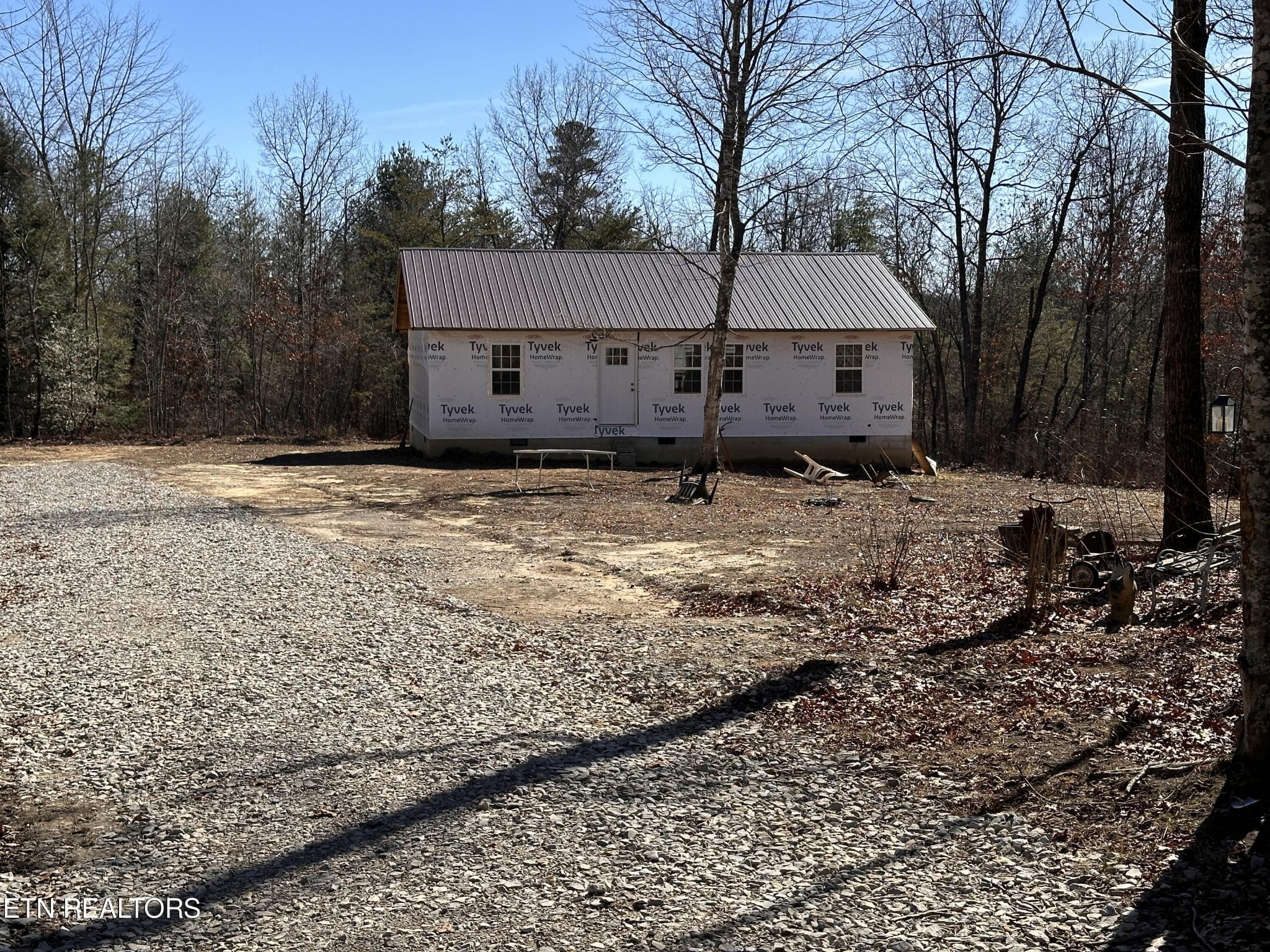 a view of a house with a yard covered in snow