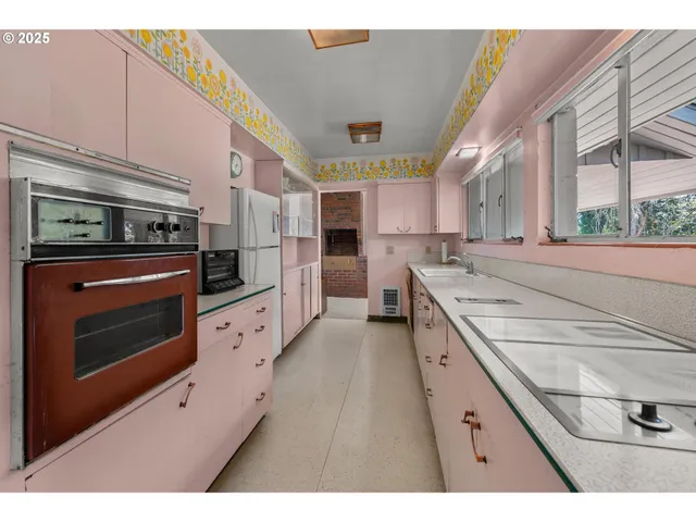 a kitchen with stainless steel appliances kitchen island granite countertop a stove a sink and a refrigerator