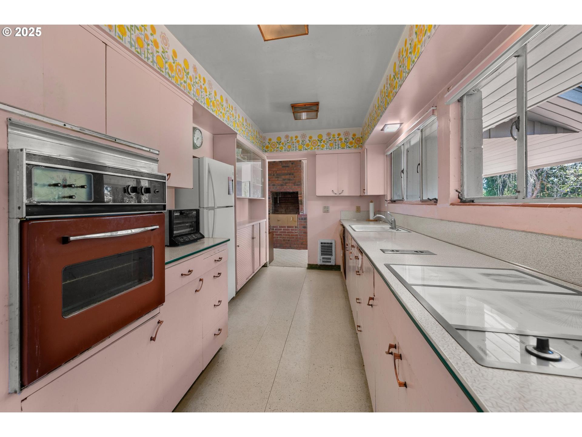 11990 Southwest Denney Road Beaverton, OR 97008 - Photo 12 of 40 a kitchen with stainless steel appliances kitchen island granite countertop a stove a sink and a refrigerator