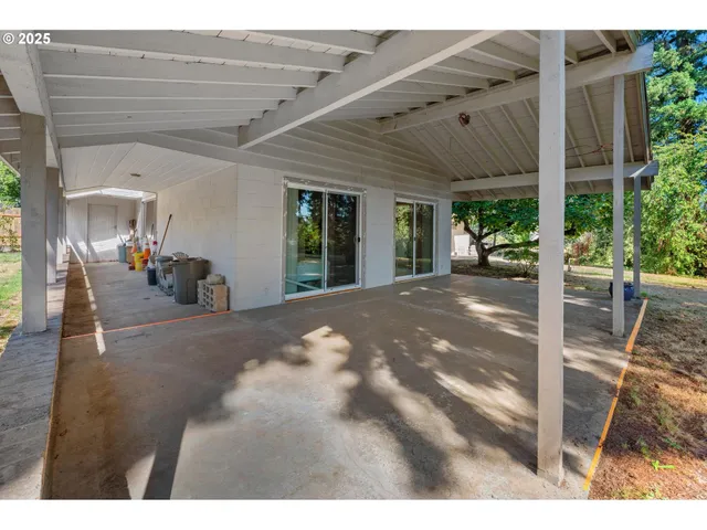 a view of a patio with table and chairs