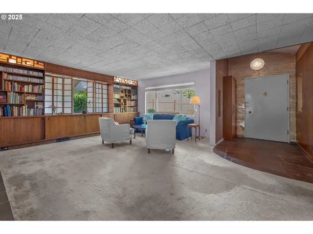 a living room with furniture and large window