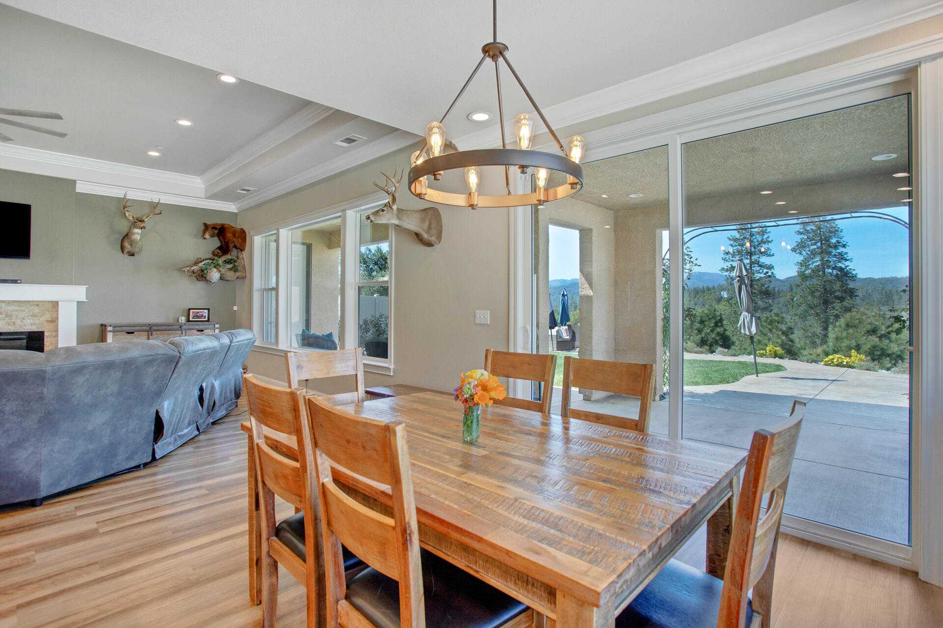 4321 Risstay Way Shasta Lake, CA 96019 - Photo 12 of 38 a dining room with furniture a chandelier and wooden floor