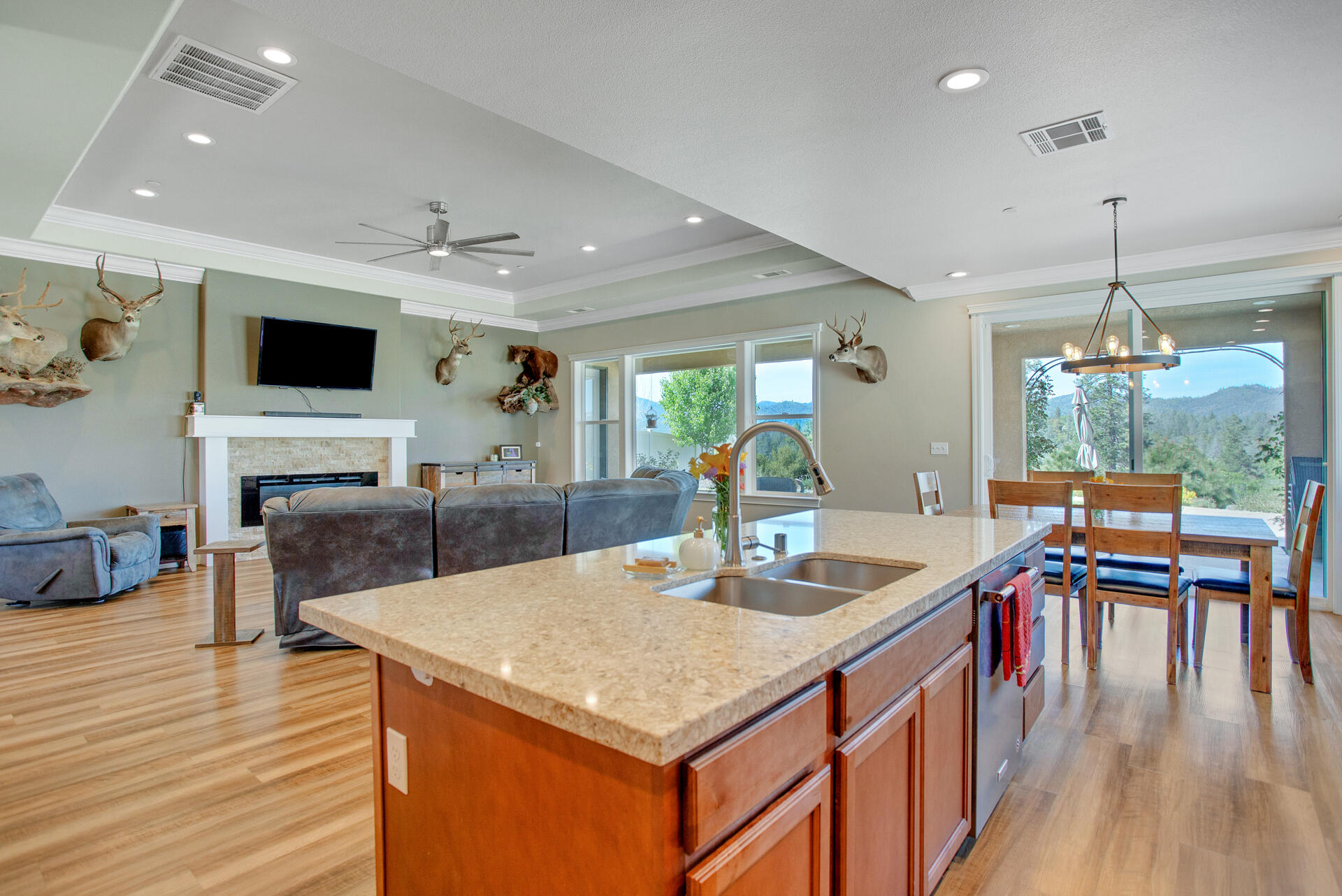 4321 Risstay Way Shasta Lake, CA 96019 - Photo 13 of 38 a kitchen with a table chairs and flat screen tv