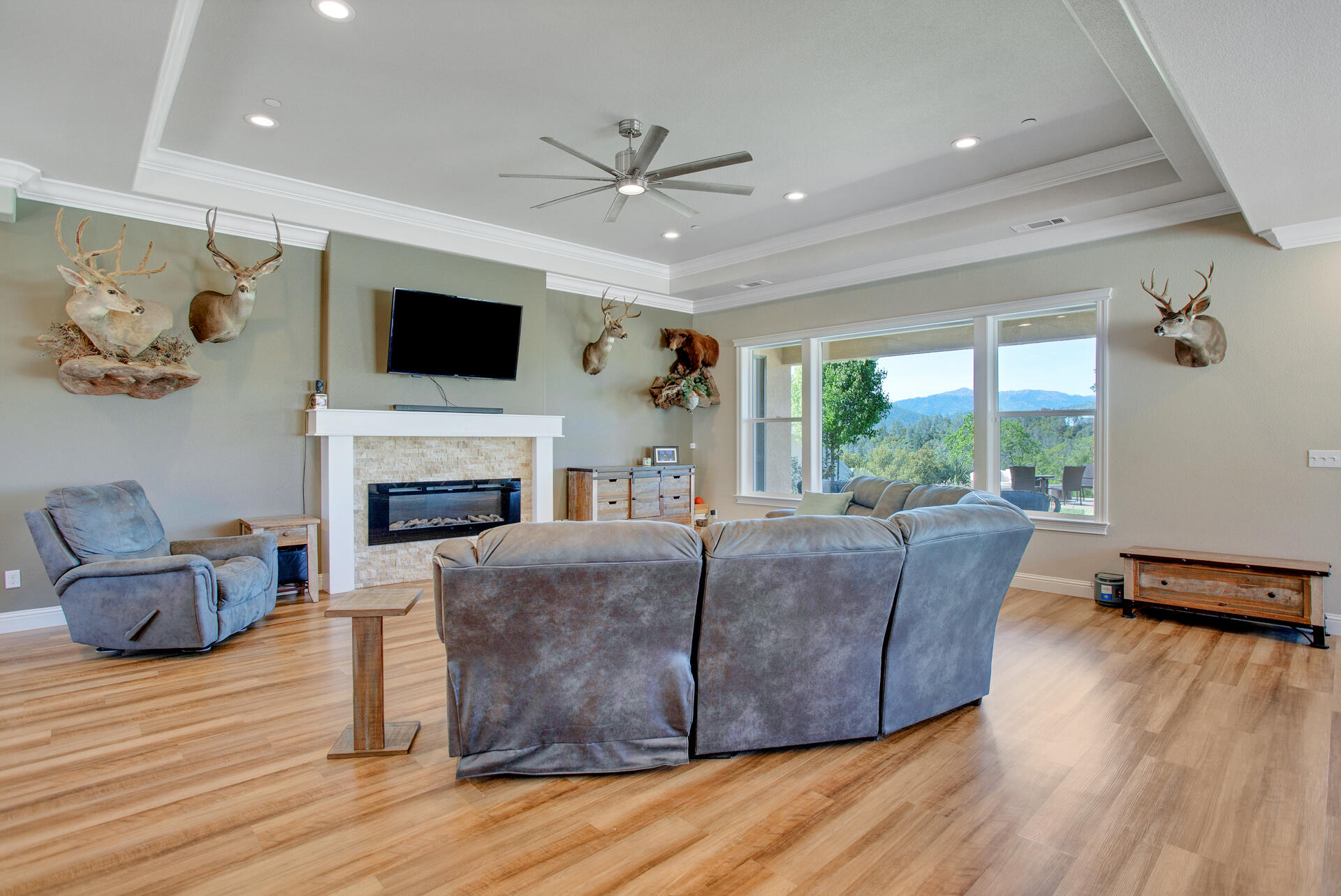 4321 Risstay Way Shasta Lake, CA 96019 - Photo 14 of 38 a living room with furniture a flat screen tv and a fireplace