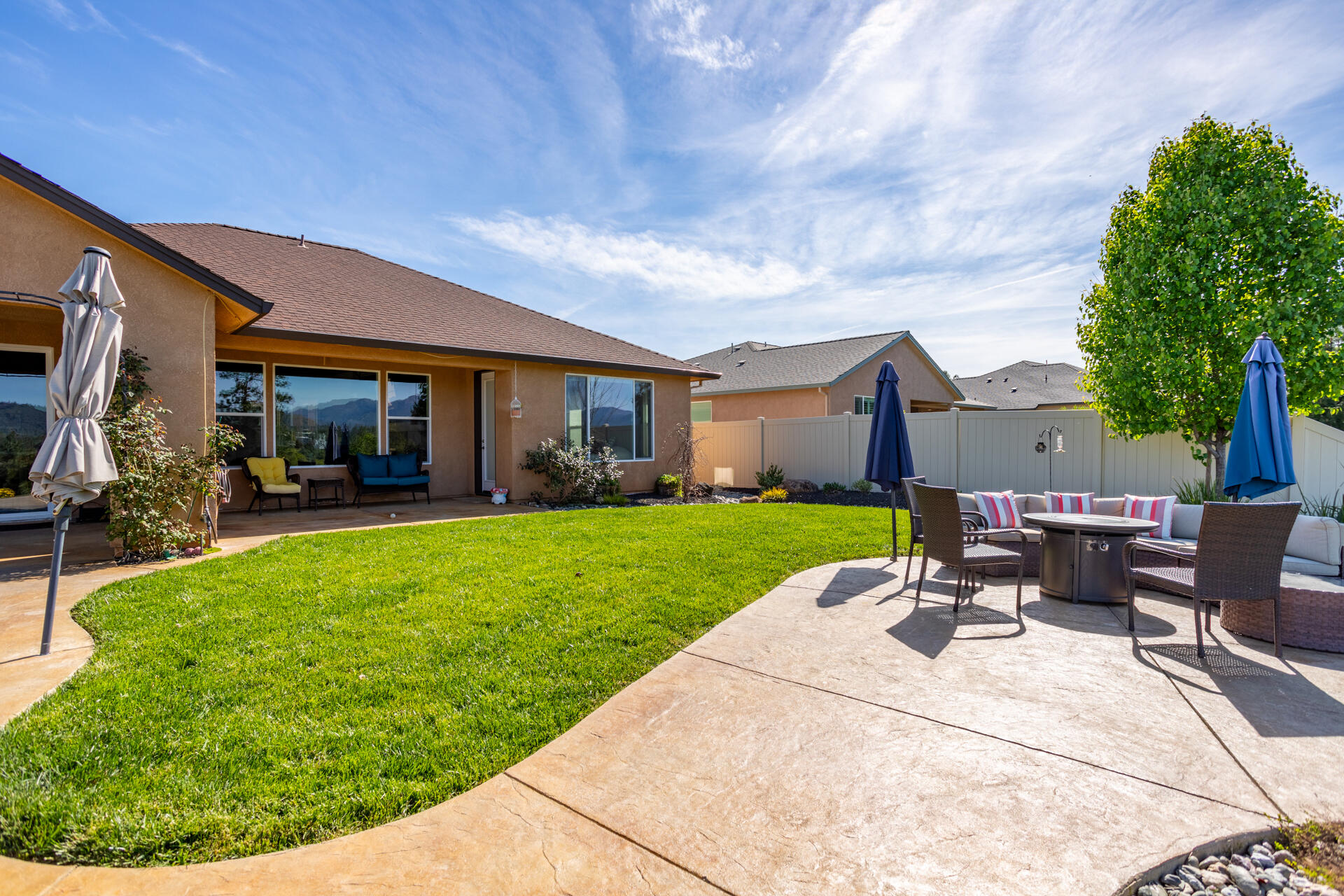 4321 Risstay Way Shasta Lake, CA 96019 - Photo 31 of 38 a view of a patio with table and chairs with a garden and plants
