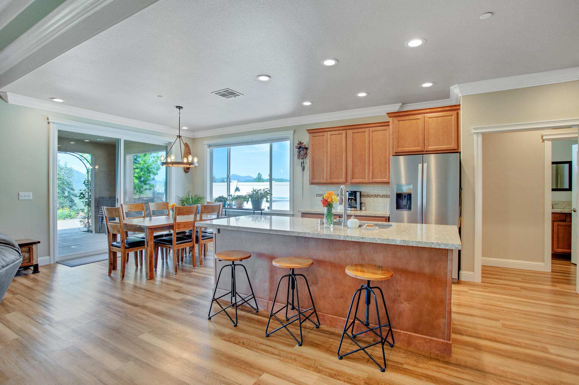 4321 Risstay Way Shasta Lake, CA 96019 - Photo 6 of 38 a kitchen with stainless steel appliances granite countertop dining table chairs refrigerator and cabinets