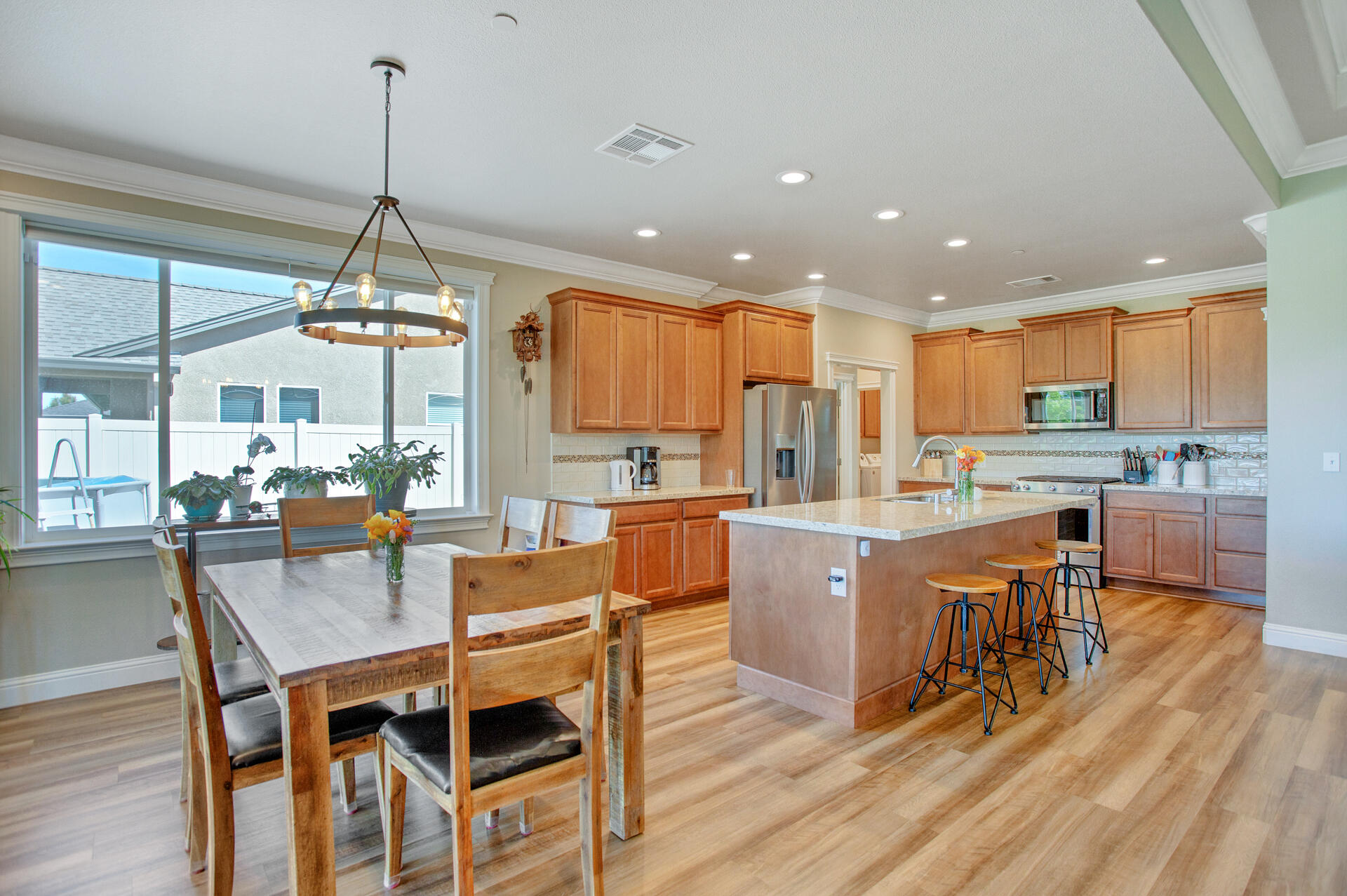 4321 Risstay Way Shasta Lake, CA 96019 - Photo 7 of 38 a view of a dining room and livingroom with furniture wooden floor a chandelier