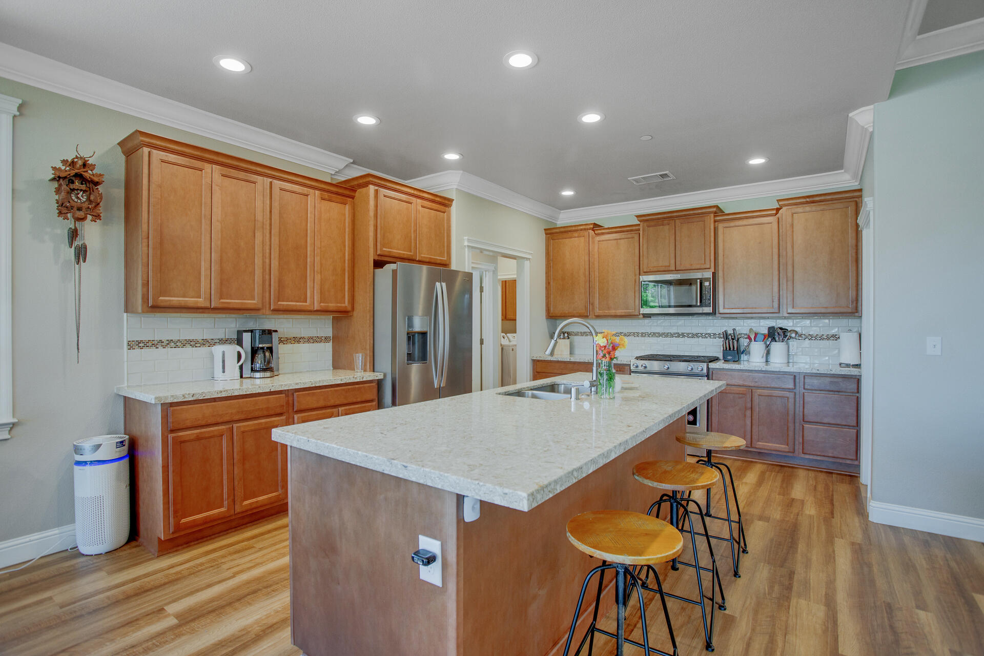 4321 Risstay Way Shasta Lake, CA 96019 - Photo 9 of 38 a kitchen with stainless steel appliances granite countertop a refrigerator a sink a stove and white cabinets with wooden floor