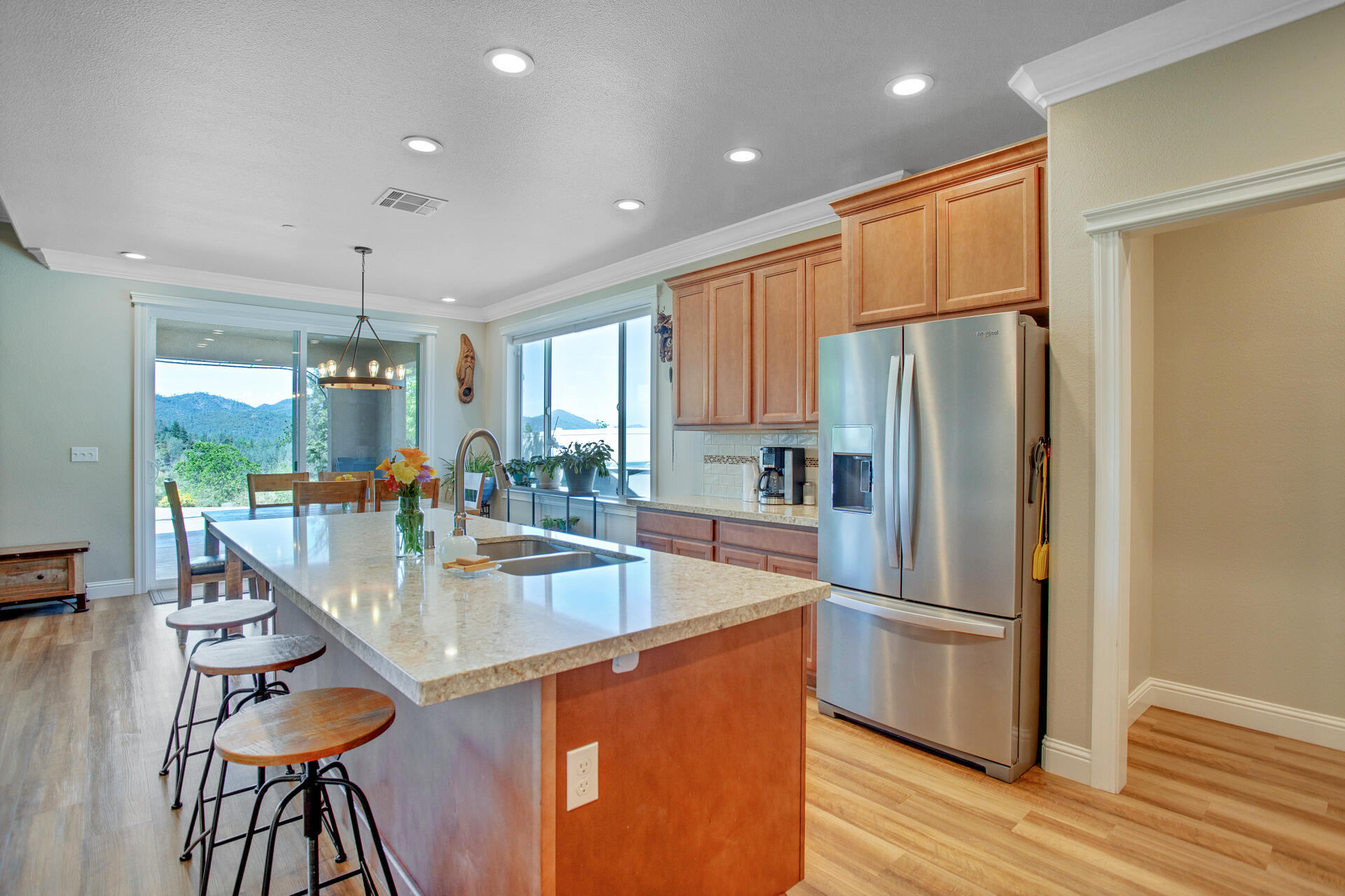 4321 Risstay Way Shasta Lake, CA 96019 - Photo 10 of 38 a kitchen with stainless steel appliances granite countertop a refrigerator a stove and a sink with wooden floor
