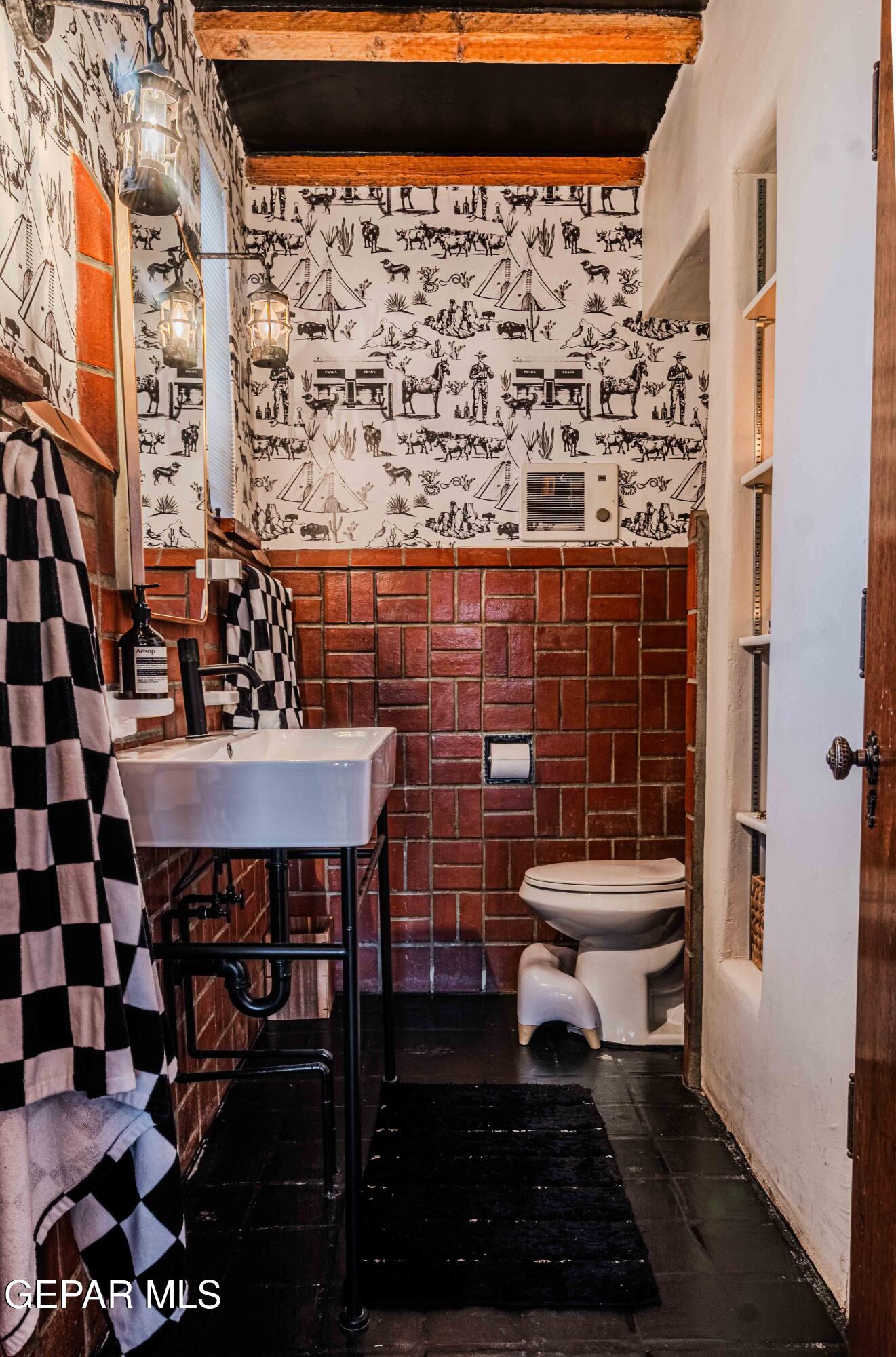 701 Rim Road El Paso, TX 79968 - Photo 14 of 54 a bathroom with a sink a toilet and a mirror