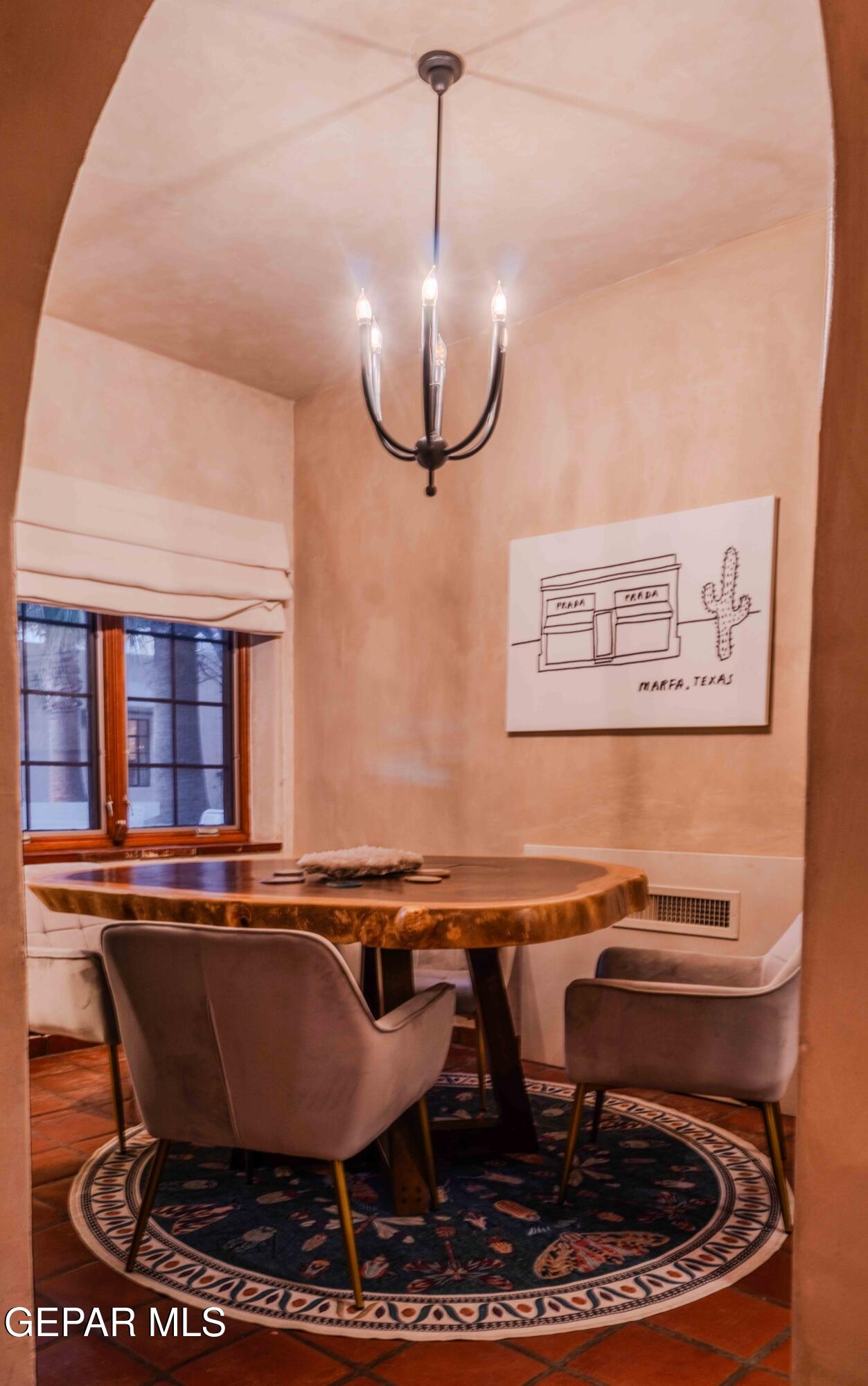 701 Rim Road El Paso, TX 79968 - Photo 21 of 54 a living room with table chairs and a potted plant