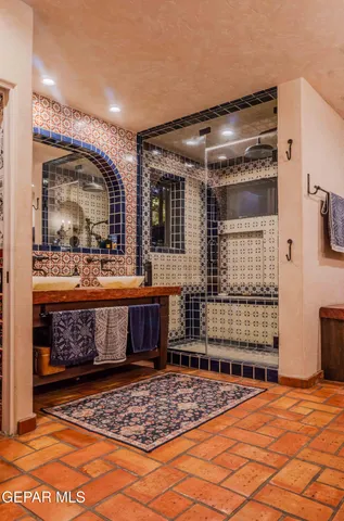 a bathroom with a sink a mirror and shower