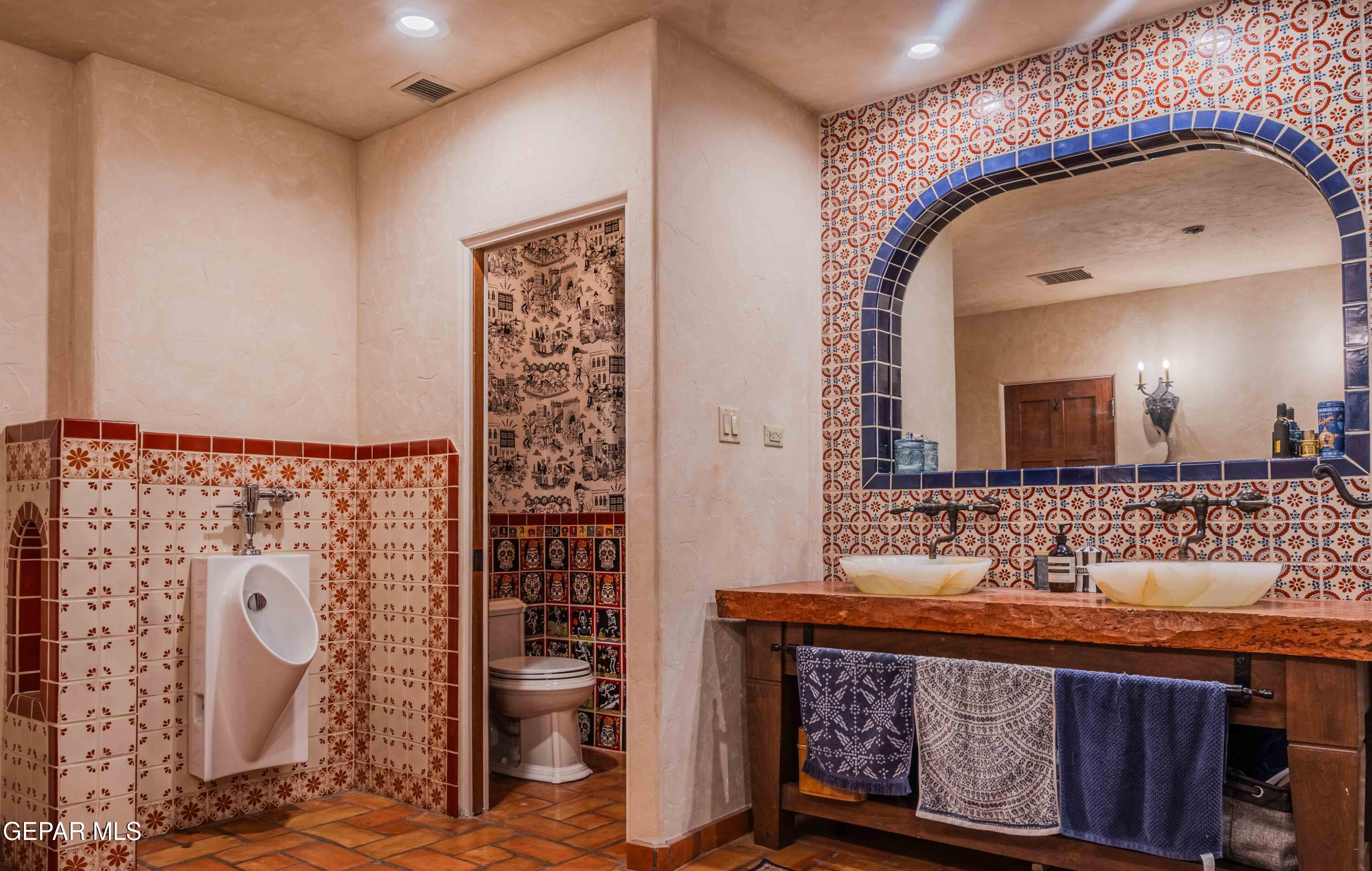 701 Rim Road El Paso, TX 79968 - Photo 27 of 54 a bathroom with a sink a mirror and shower