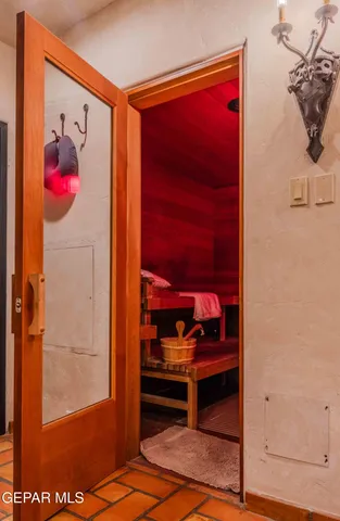 a bedroom with a large bed and a chandelier