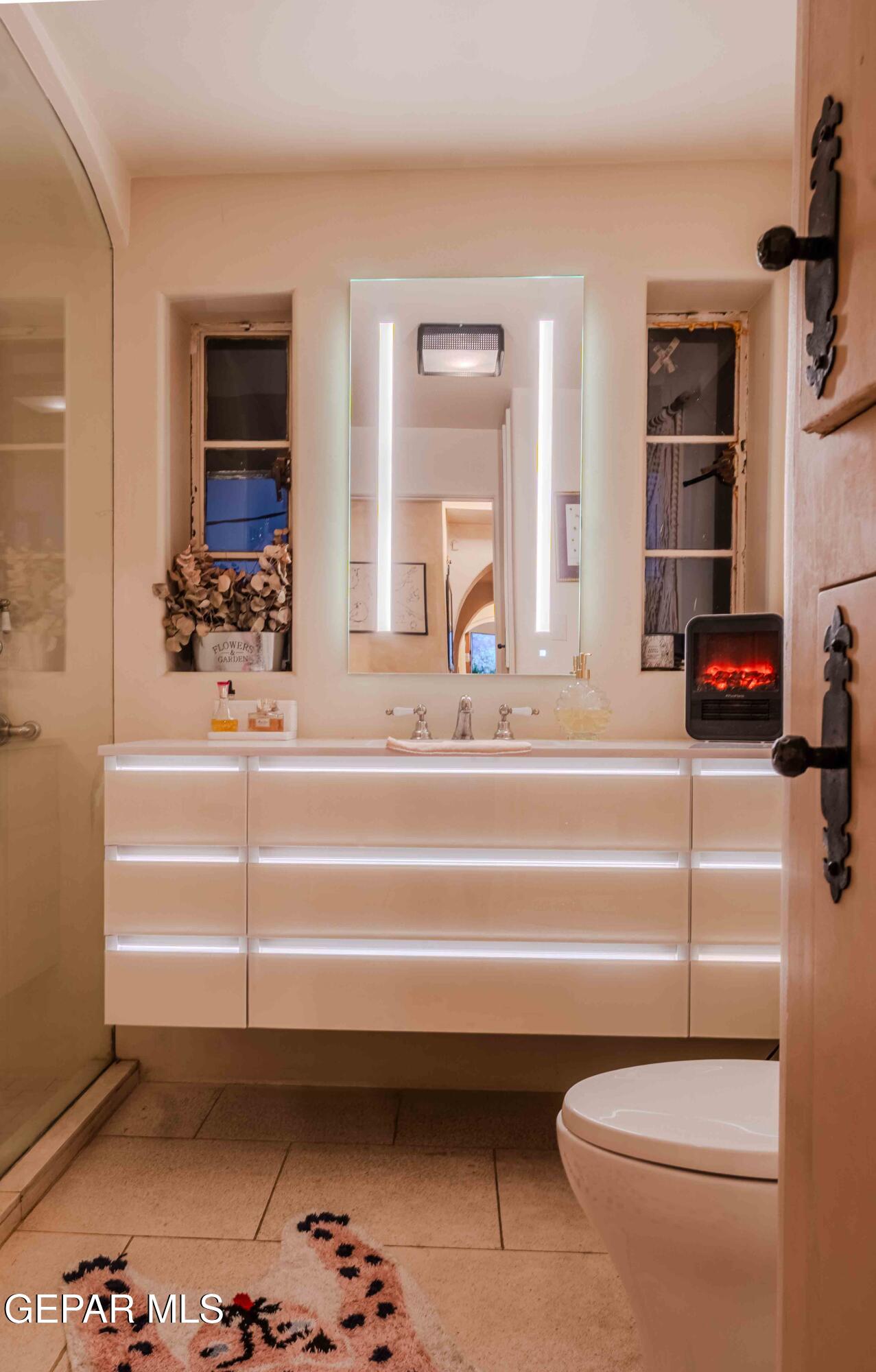 701 Rim Road El Paso, TX 79968 - Photo 32 of 54 a bathroom with a sink and a mirror