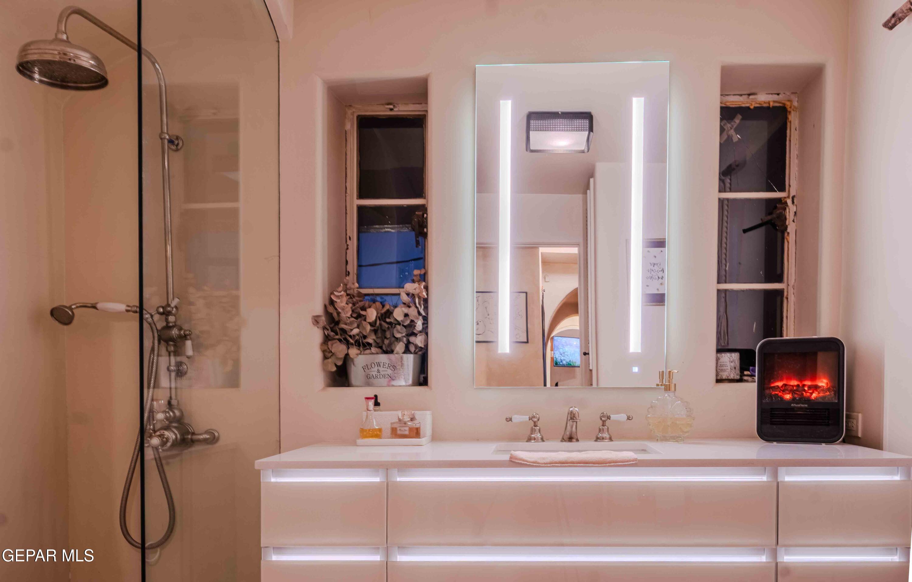 701 Rim Road El Paso, TX 79968 - Photo 33 of 54 a bathroom with a sink and a mirror