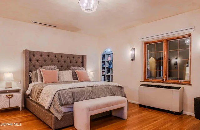 a bathroom with a bathtub and chandelier