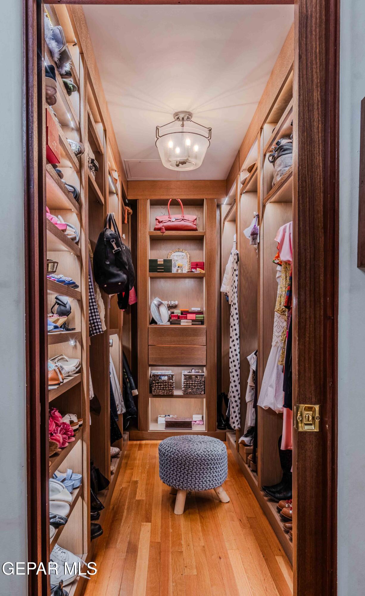 701 Rim Road El Paso, TX 79968 - Photo 36 of 54 a view of walk in closet with clothes and shoes