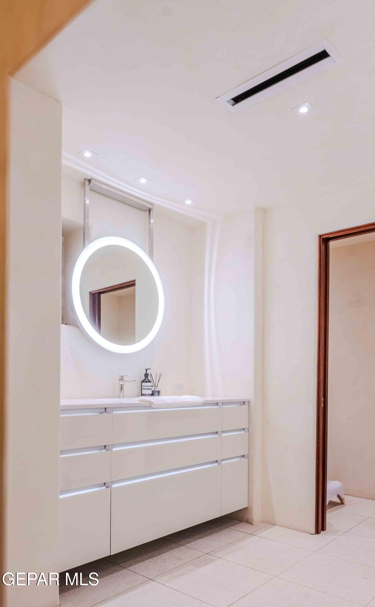 701 Rim Road El Paso, TX 79968 - Photo 38 of 54 a bathroom with a sink and a mirror