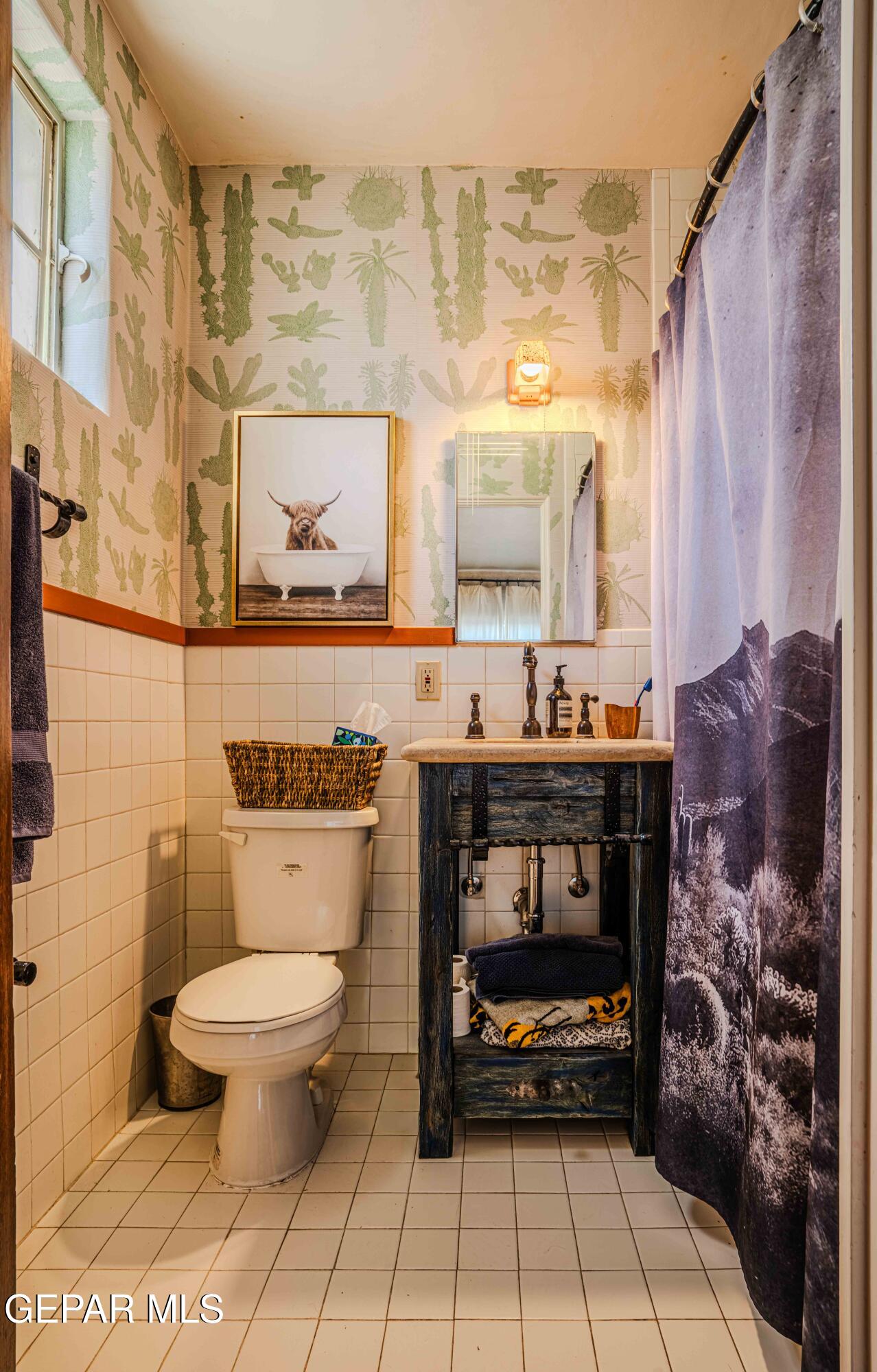 701 Rim Road El Paso, TX 79968 - Photo 41 of 54 a bathroom with a toilet a sink and a shower curtain