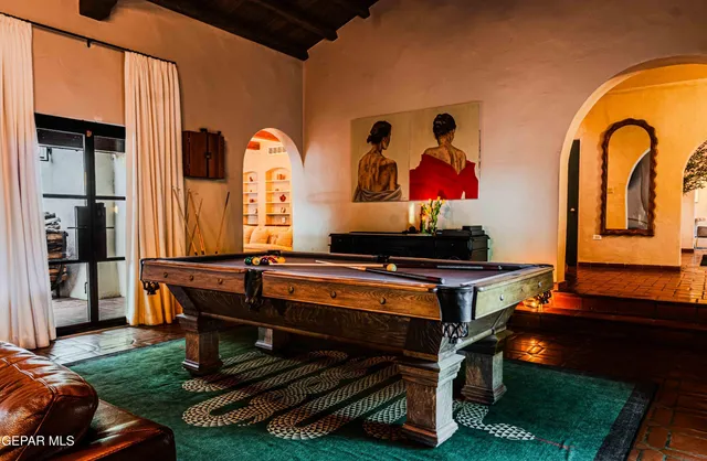 a living room with blue lights with furniture