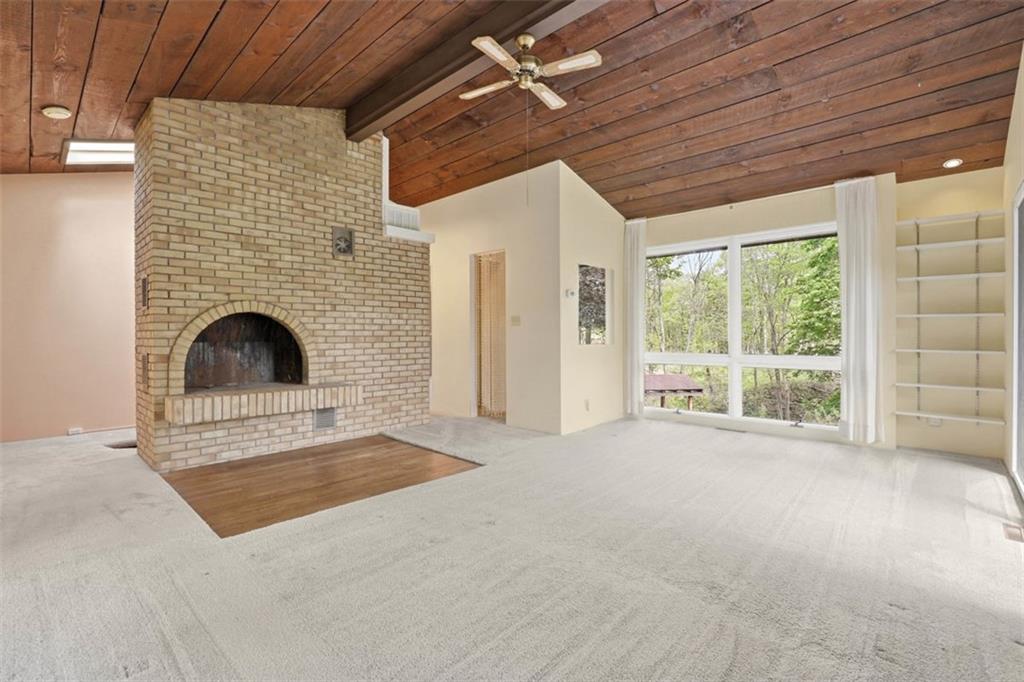 134 Meredith Drive Mars, PA 16046 - Photo 27 of 46 a view of an empty room with a fireplace and a window