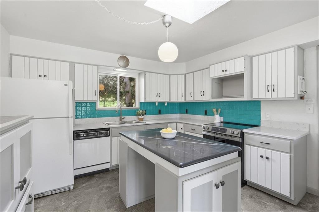 134 Meredith Drive Mars, PA 16046 - Photo 8 of 46 a kitchen with granite countertop a sink and a refrigerator