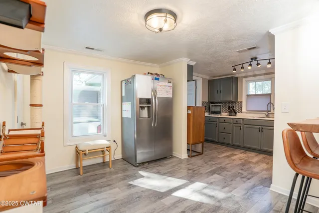 a kitchen with a refrigerator and a sink