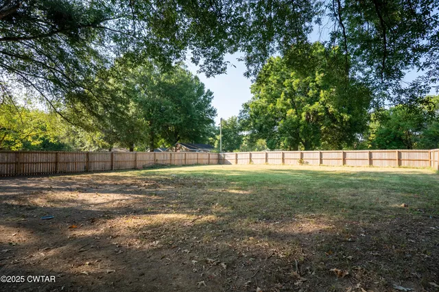 a view of a field with trees